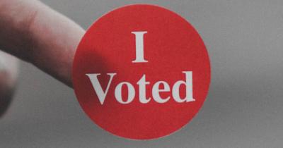 Close up of a red "I Voted" sticker.