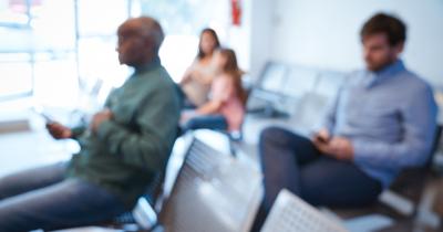 Defocused image of people sitting in an agency waiting room