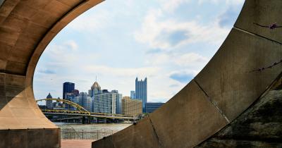 Pittsburgh skyline seen through the Fred Rogers Memorial Monument in foreground