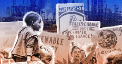 Smiling Black boy sitting on his father's shoulders as they walk through a climate crisis protest