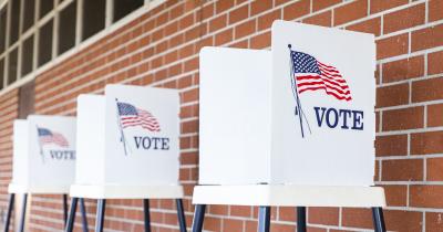 Three empty voting booths outside