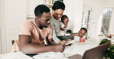 Black Family Around the Table Paying Bills