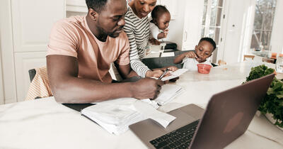 Black Family Around the Table Paying Bills