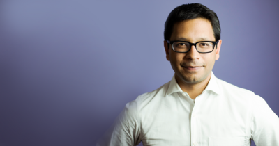 K. Sabeel Rahman standing against purple background