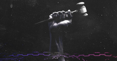 Black fist holding a gavel and breaking free of chains