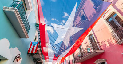 Large flag of Puerto Rico above the street in the city center of San Juan.
