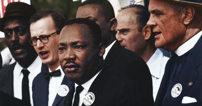Dr. Martin Luther King standing along other civil rights organizers at a march