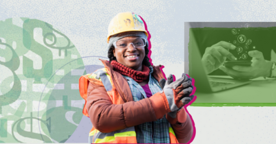 Black construction worker smiling at the camera with hands clasped