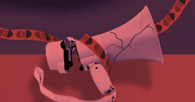 A broken megaphone wrapped in red tape that is dotted with I Voted stickers