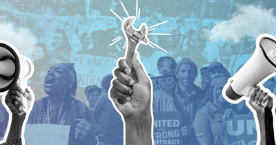 Symbols of organizing and activism in front of a group of people holding signs