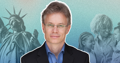 An man in a suit is featured in front of a blue background with black and white images of the statue of liberty and a family