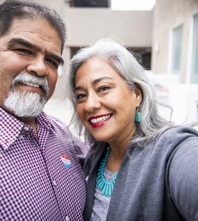 Smiling Latino couple who just voted