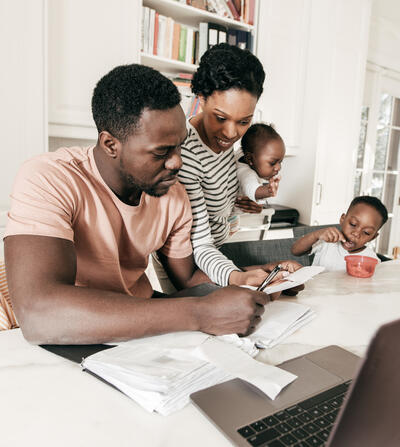 Black Family Around the Table Paying Bills