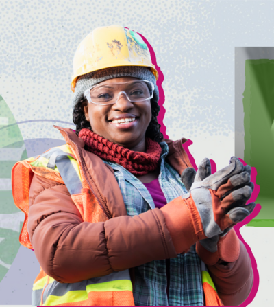 Black construction worker smiling at the camera with hands clasped