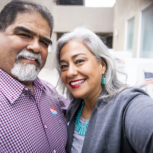 Smiling Latino couple who just voted