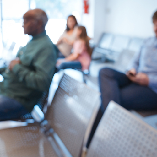 Defocused image of people sitting in an agency waiting room