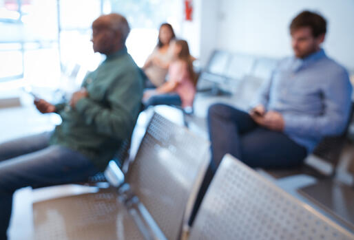 Defocused image of people sitting in an agency waiting room