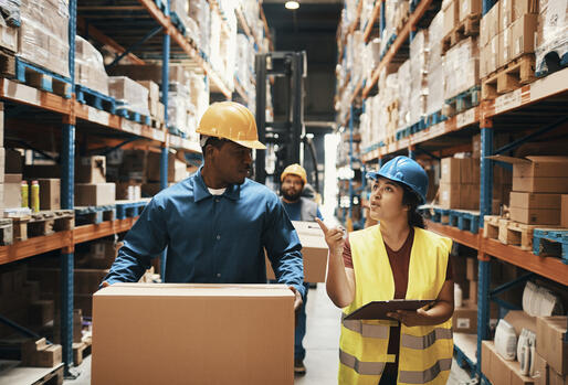Workers walking and talking in a warehouse