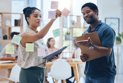 People working together putting post-its on the wall