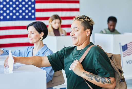 Multiracial Voters Putting Ballots in Bin