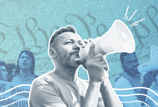 Organizer with a bull horn in front of a rally line