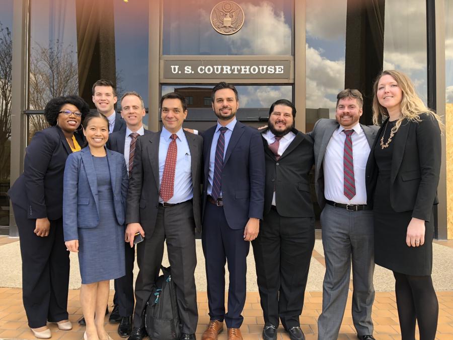 Demos and co-counsel in front of Texas courthouse